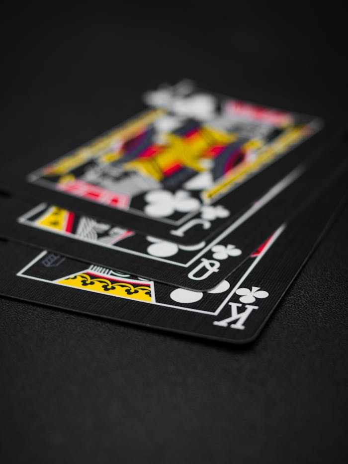 Intriguing close-up of black playing cards featuring king, queen, and jack, perfect for gambling concepts.